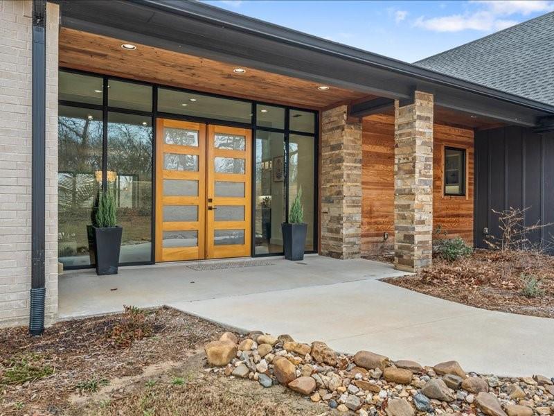 Contemporary custom ranch home built in 2024 nestled in a private forest on 6 acres.