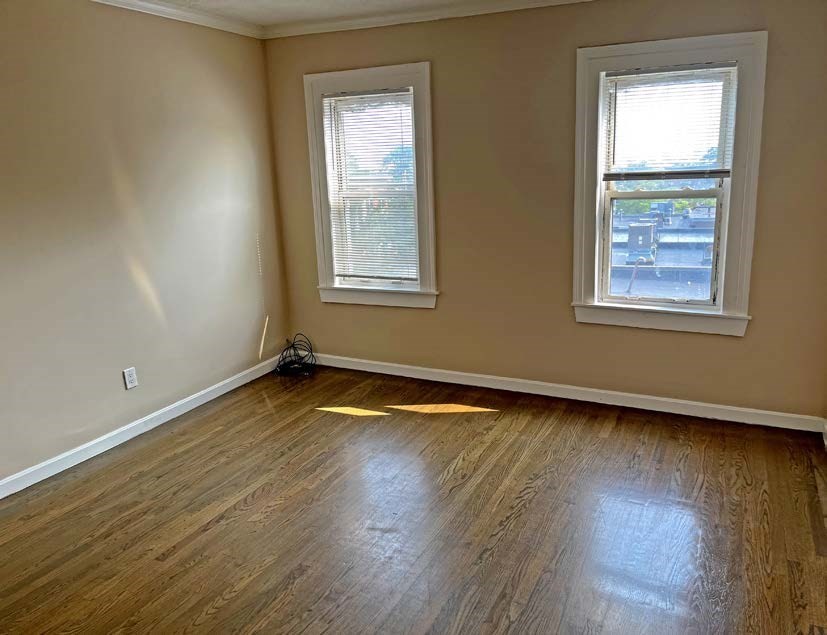 3106-3110 Washington Street Boston, MA 02119 - Photo 12 of 16 a view of an empty room with wooden floor and a window