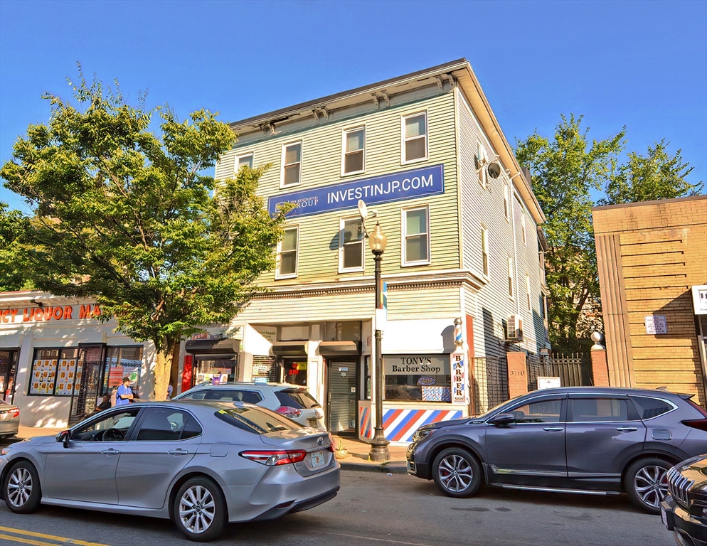 3106-3110 Washington Street Boston, MA 02119 - Photo 2 of 16 a car parked in front of a house
