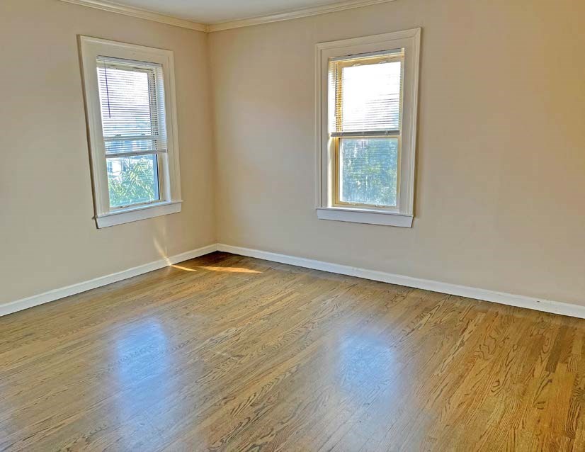 3106-3110 Washington Street Boston, MA 02119 - Photo 8 of 16 a view of an empty room with wooden floor and a window