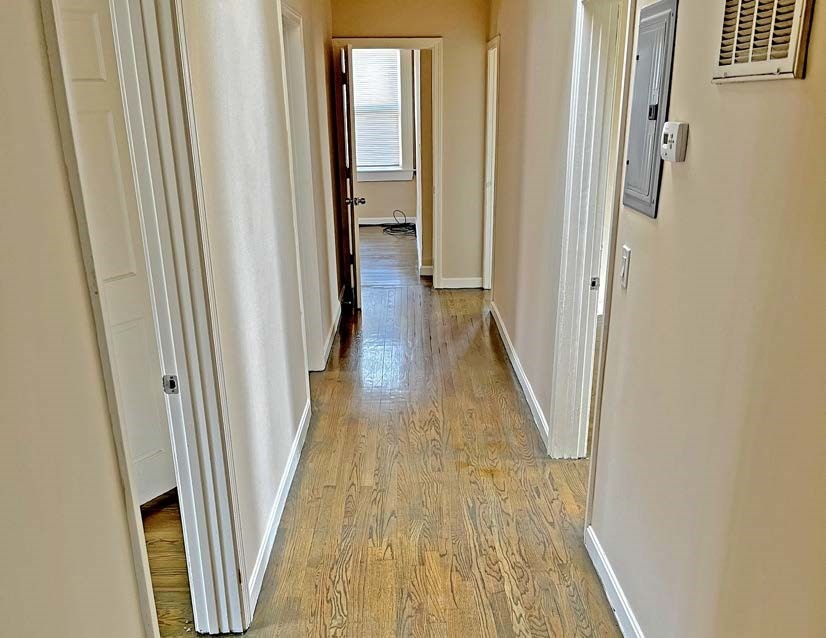 3106-3110 Washington Street Boston, MA 02119 - Photo 9 of 16 a view of a hallway with wooden floor and staircase