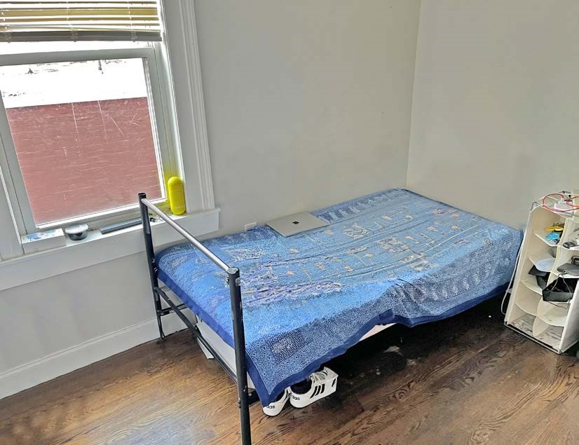 3106-3110 Washington Street Boston, MA 02119 - Photo 10 of 16 a bed sitting in a bedroom next to a window