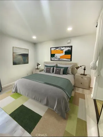 a bedroom with furniture and a flat screen tv