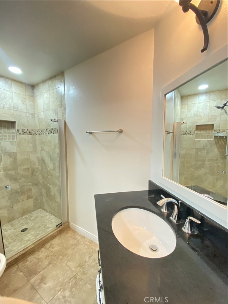 18645 Hatteras Street, Unit 278 Tarzana, CA 91356 - Photo 14 of 37 a bathroom with a sink and a mirror