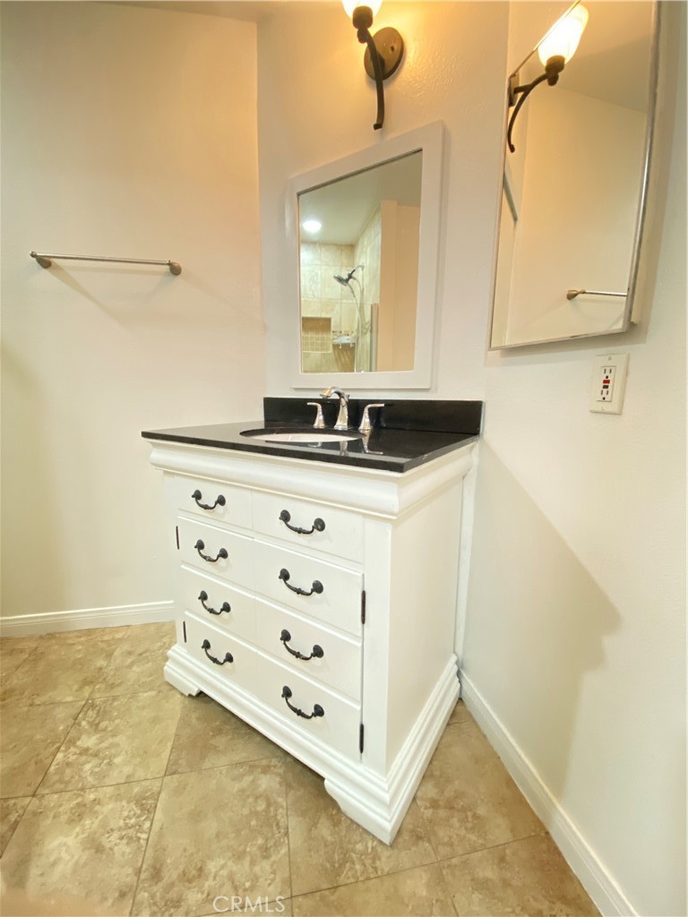 18645 Hatteras Street, Unit 278 Tarzana, CA 91356 - Photo 15 of 37 a bathroom with a sink a vanity and a mirror