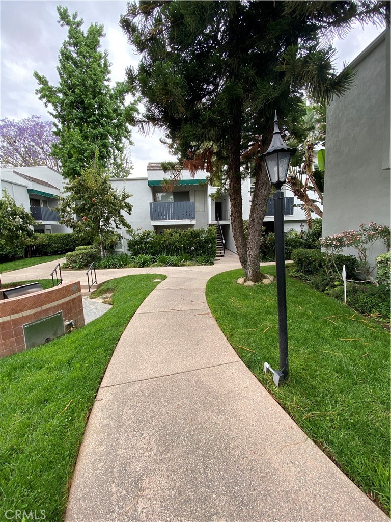 18645 Hatteras Street, Unit 278 Tarzana, CA 91356 - Photo 24 of 37 a front view of a house with garden