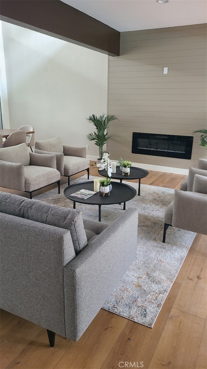 18645 Hatteras Street, Unit 278 Tarzana, CA 91356 - Photo 34 of 37 a living room with furniture and a potted plant