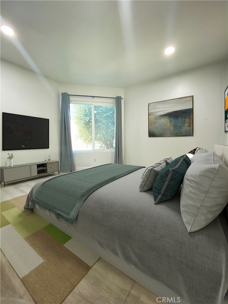 18645 Hatteras Street, Unit 278 Tarzana, CA 91356 - Photo 9 of 37 a bedroom with a bed and a flat screen tv