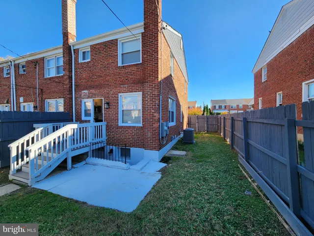 a view of a house with a yard and deck