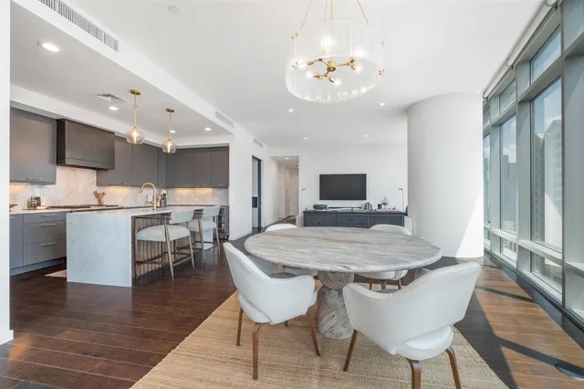 a living room with furniture and a view of kitchen