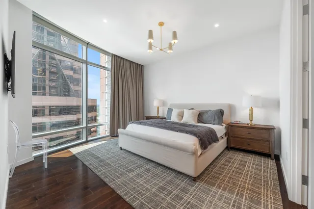 a bedroom with a bed and a flat screen tv