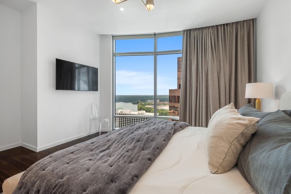 200 Congress Avenue, Unit 19F Austin, TX 78701 - Photo 19 of 40 a bedroom with a bed and a flat screen tv