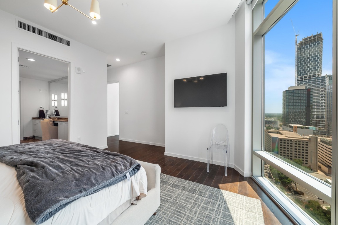 200 Congress Avenue, Unit 19F Austin, TX 78701 - Photo 20 of 40 a bedroom with a bed and a flat screen tv