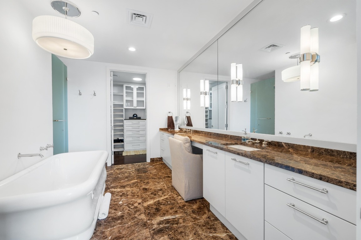 200 Congress Avenue, Unit 19F Austin, TX 78701 - Photo 21 of 40 a bathroom with a tub sink and mirror