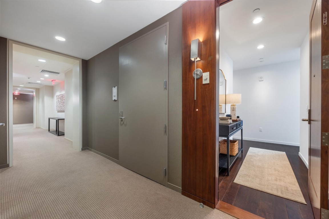200 Congress Avenue, Unit 19F Austin, TX 78701 - Photo 3 of 40 a view of hallway with a bathroom and a mirror