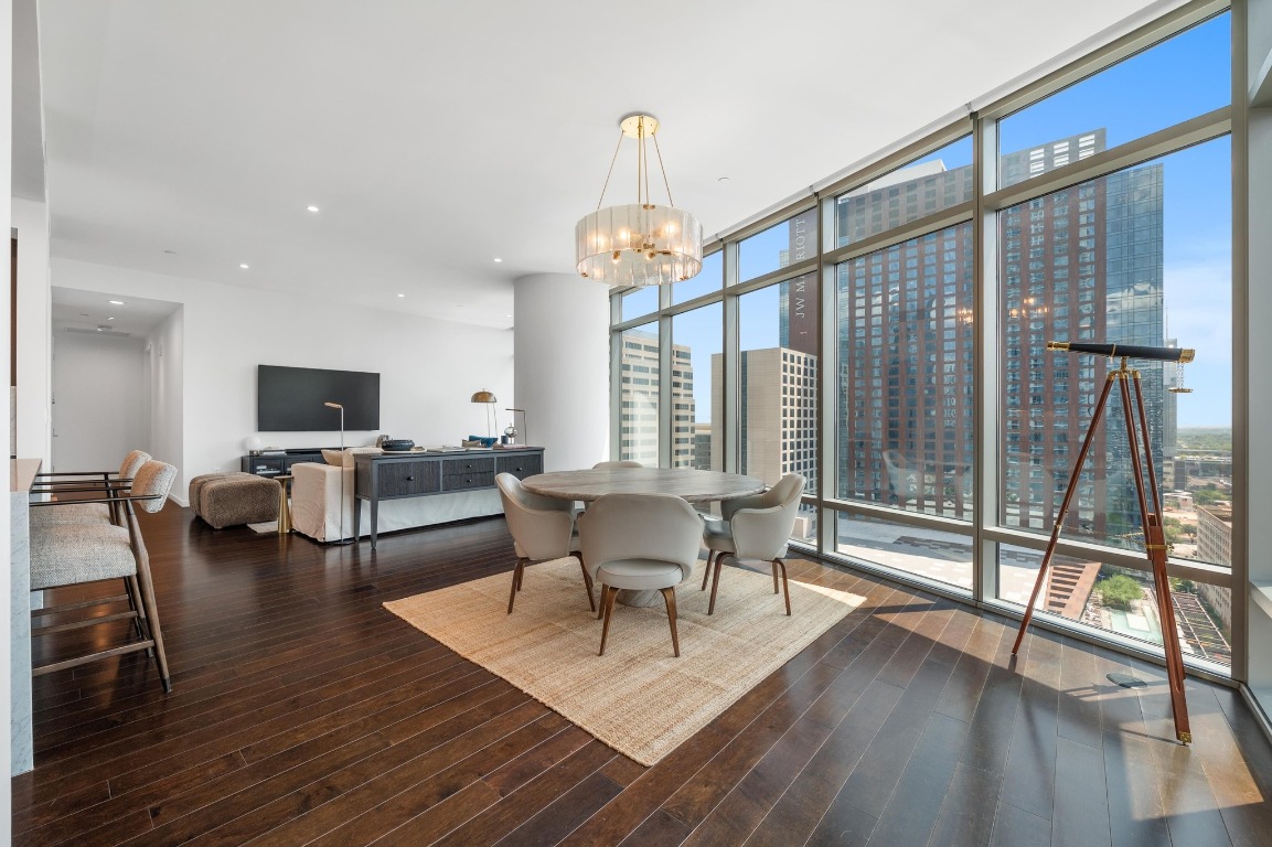 200 Congress Avenue, Unit 19F Austin, TX 78701 - Photo 4 of 40 a living room with furniture a flat screen tv and a large window