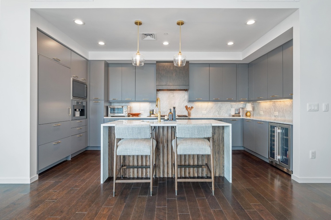 200 Congress Avenue, Unit 19F Austin, TX 78701 - Photo 9 of 40 a kitchen with a sink cabinets and wooden floor