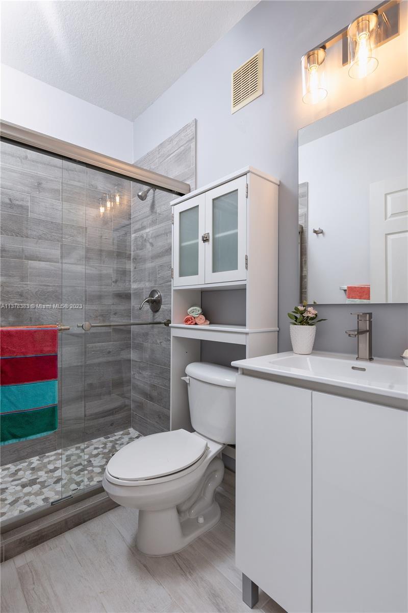 Vizcaya Miramar, FL 33027 - Photo 23 of 35 a bathroom with a toilet a sink and shower