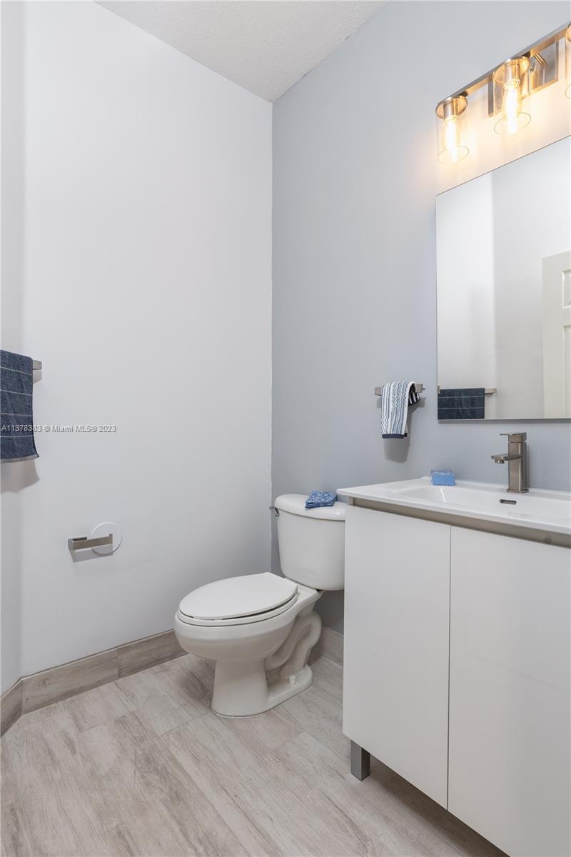 Vizcaya Miramar, FL 33027 - Photo 24 of 35 a bathroom with a toilet a sink and mirror