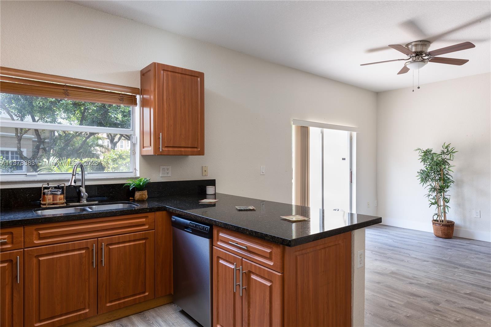 Vizcaya Miramar, FL 33027 - Photo 9 of 35 a kitchen with granite countertop a sink a counter space and cabinets