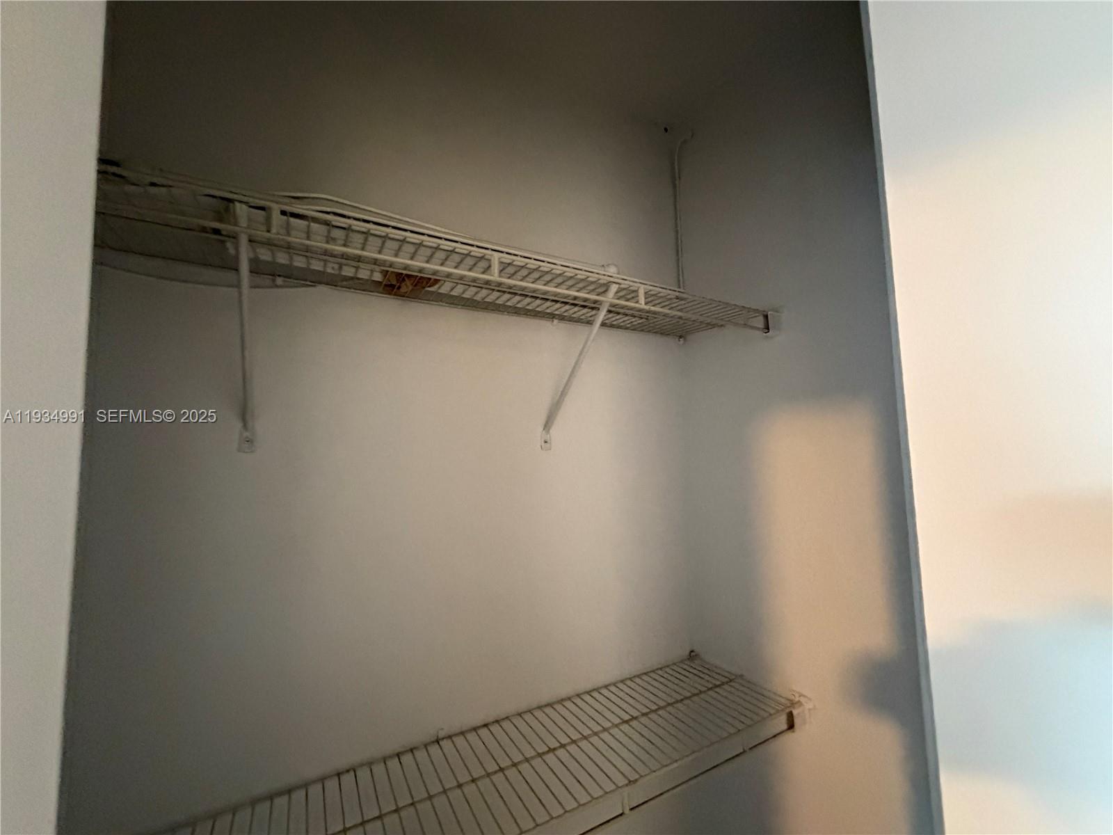 7928 Harding Avenue, Unit 1 Miami Beach, FL 33141 - Photo 10 of 12 a view of a room with racks on the wall