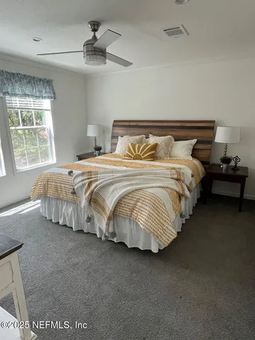 a bedroom with bed and window