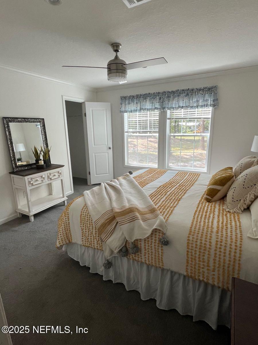 540324 Lem Turner Road Callahan, FL 32011 - Photo 13 of 25 a bedroom with a bed and large mirror