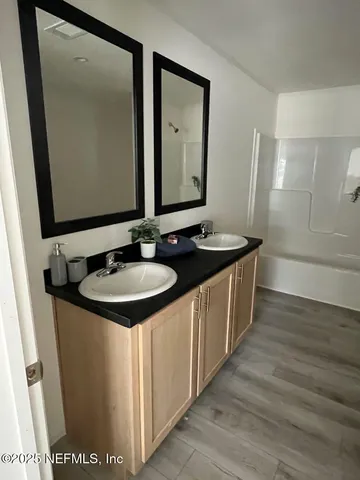 a bathroom with sink and mirror