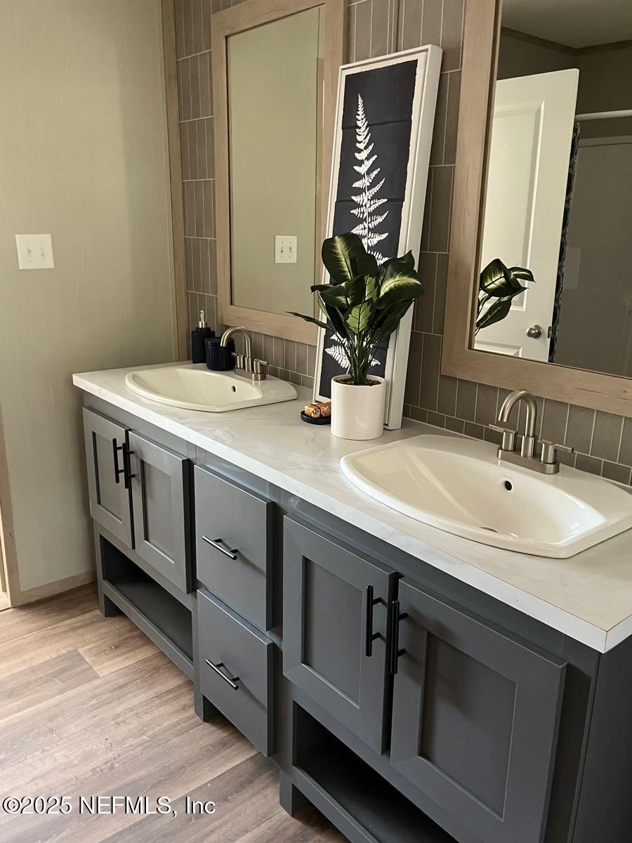 540324 Lem Turner Road Callahan, FL 32011 - Photo 16 of 25 a bathroom with a double vanity sink and a mirror