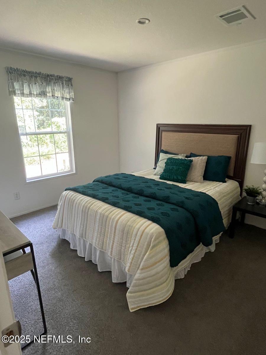540324 Lem Turner Road Callahan, FL 32011 - Photo 20 of 25 a bedroom with a bed and window