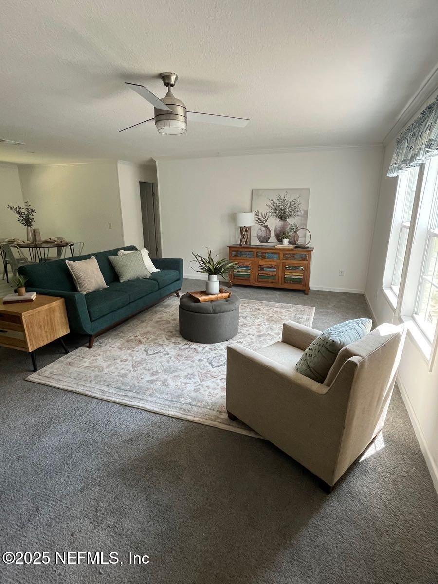 540324 Lem Turner Road Callahan, FL 32011 - Photo 2 of 25 a living room with furniture and a chandelier