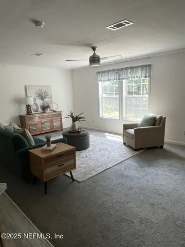 a living room with furniture and a large window