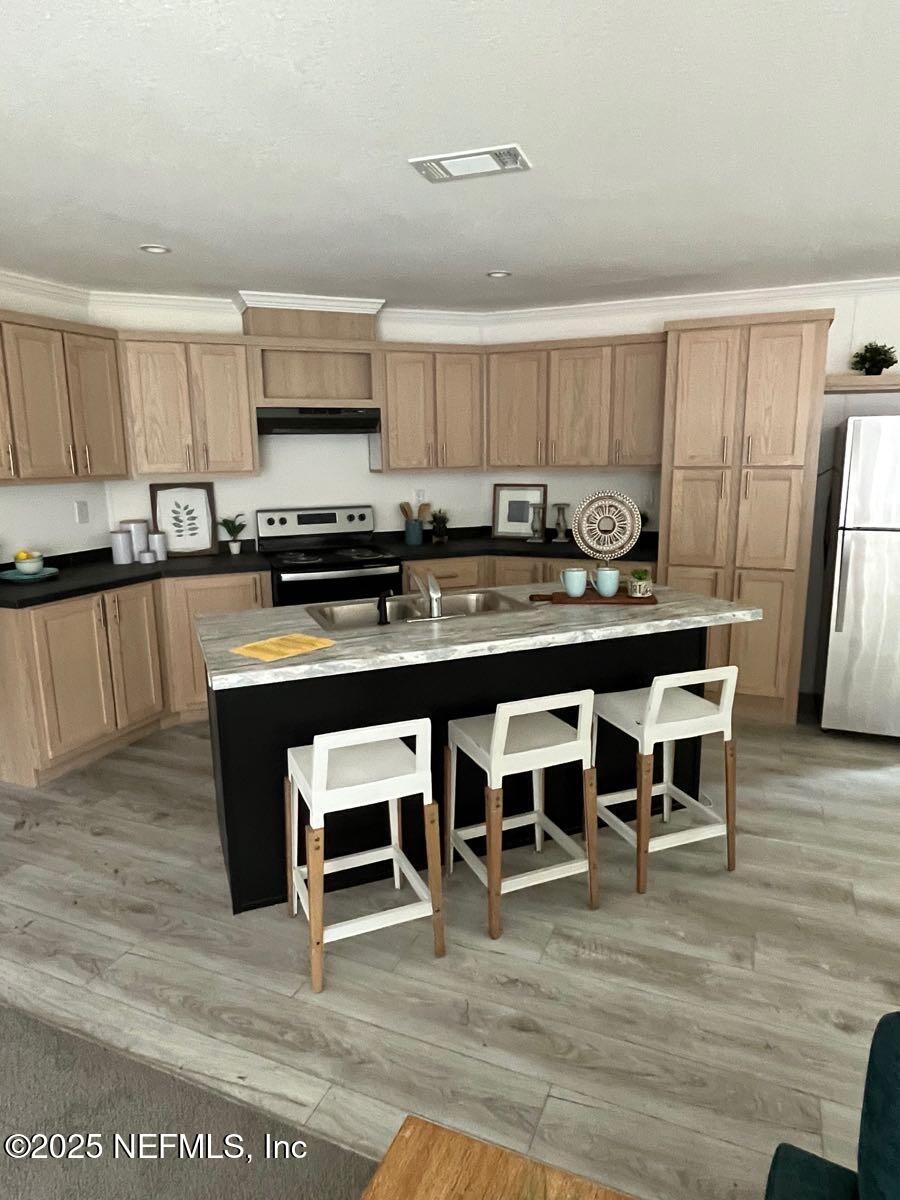 540324 Lem Turner Road Callahan, FL 32011 - Photo 6 of 25 a kitchen with stainless steel appliances granite countertop a table chairs sink and cabinets