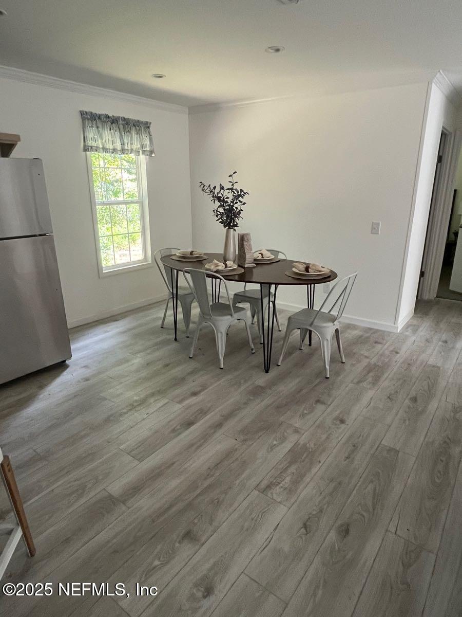 540324 Lem Turner Road Callahan, FL 32011 - Photo 10 of 25 a view of a dining room with furniture and wooden floor