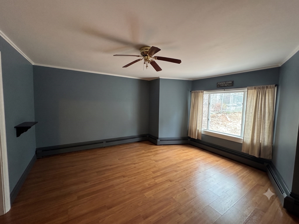 27 High Street Sturbridge, MA 01518 - Photo 4 of 17 an empty room with wooden floor and windows