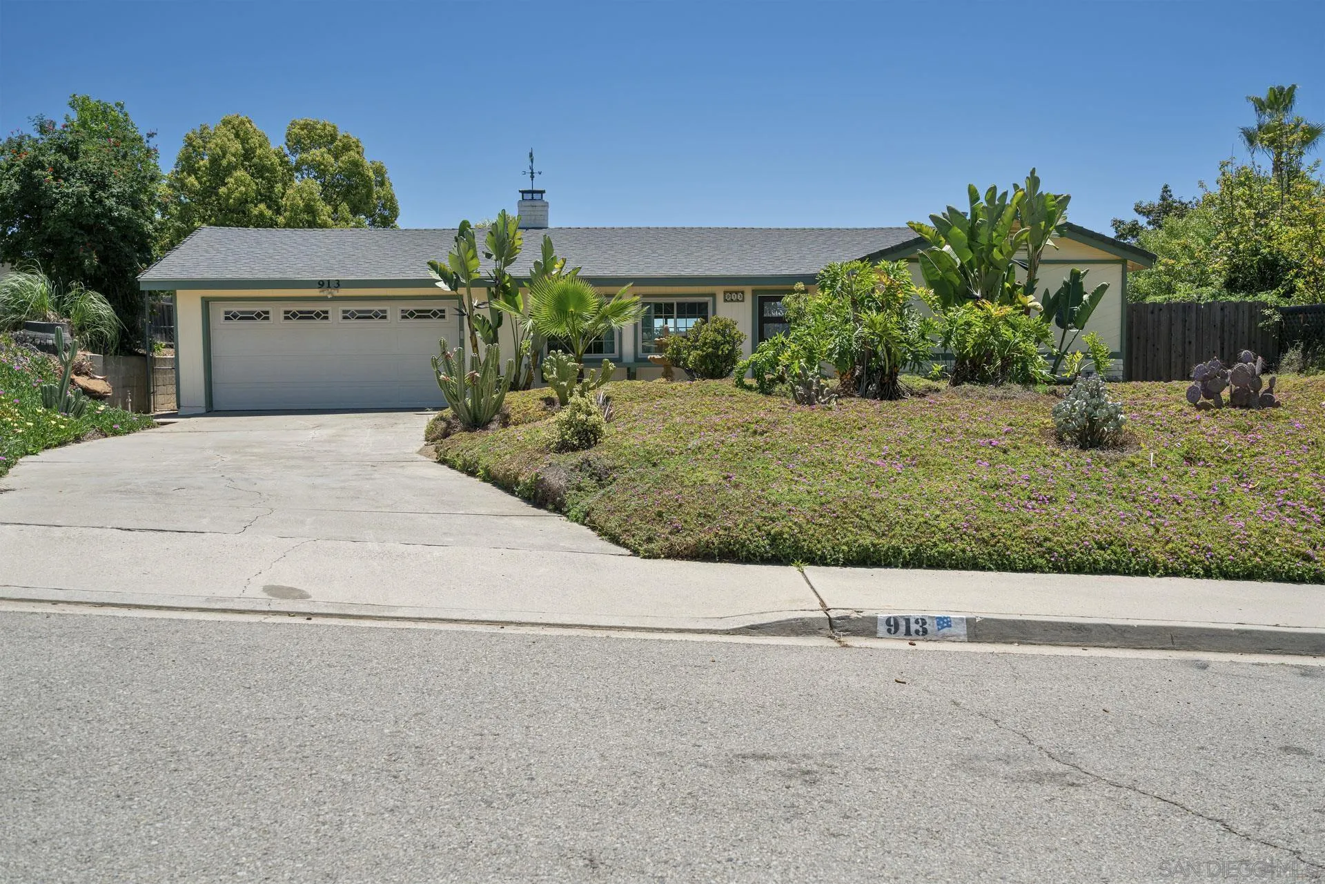 a front view of a house with a yard and a garage