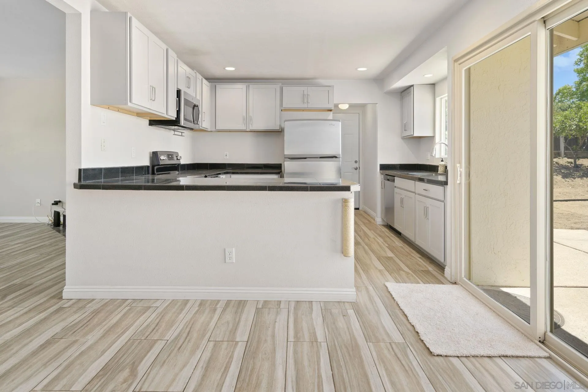 913 Buena Rosa Court Fallbrook, CA 92028 - Photo 11 of 45 a kitchen with stainless steel appliances granite countertop a stove a sink and a refrigerator