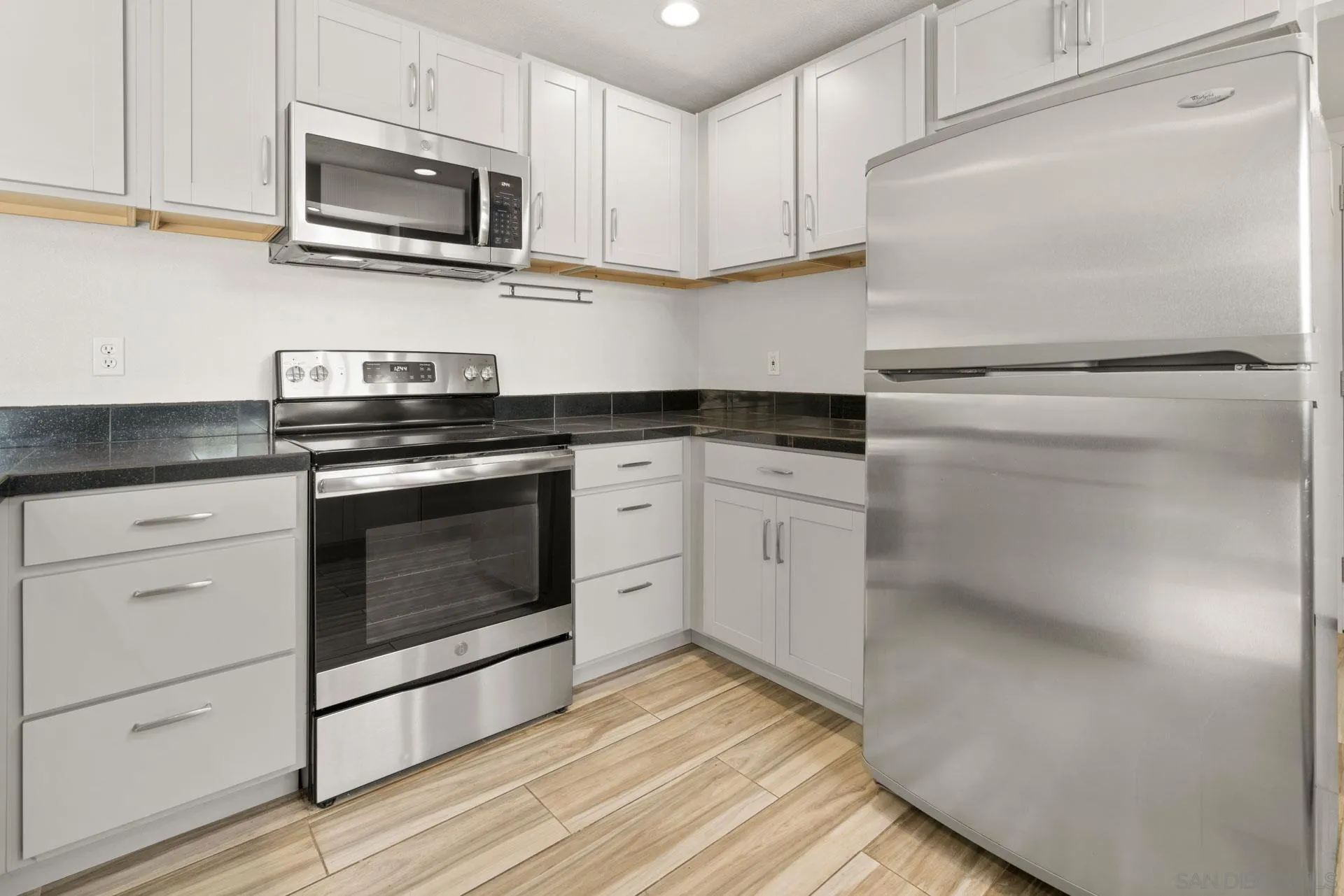 913 Buena Rosa Court Fallbrook, CA 92028 - Photo 13 of 45 a kitchen with stainless steel appliances granite countertop a stove a microwave and a refrigerator