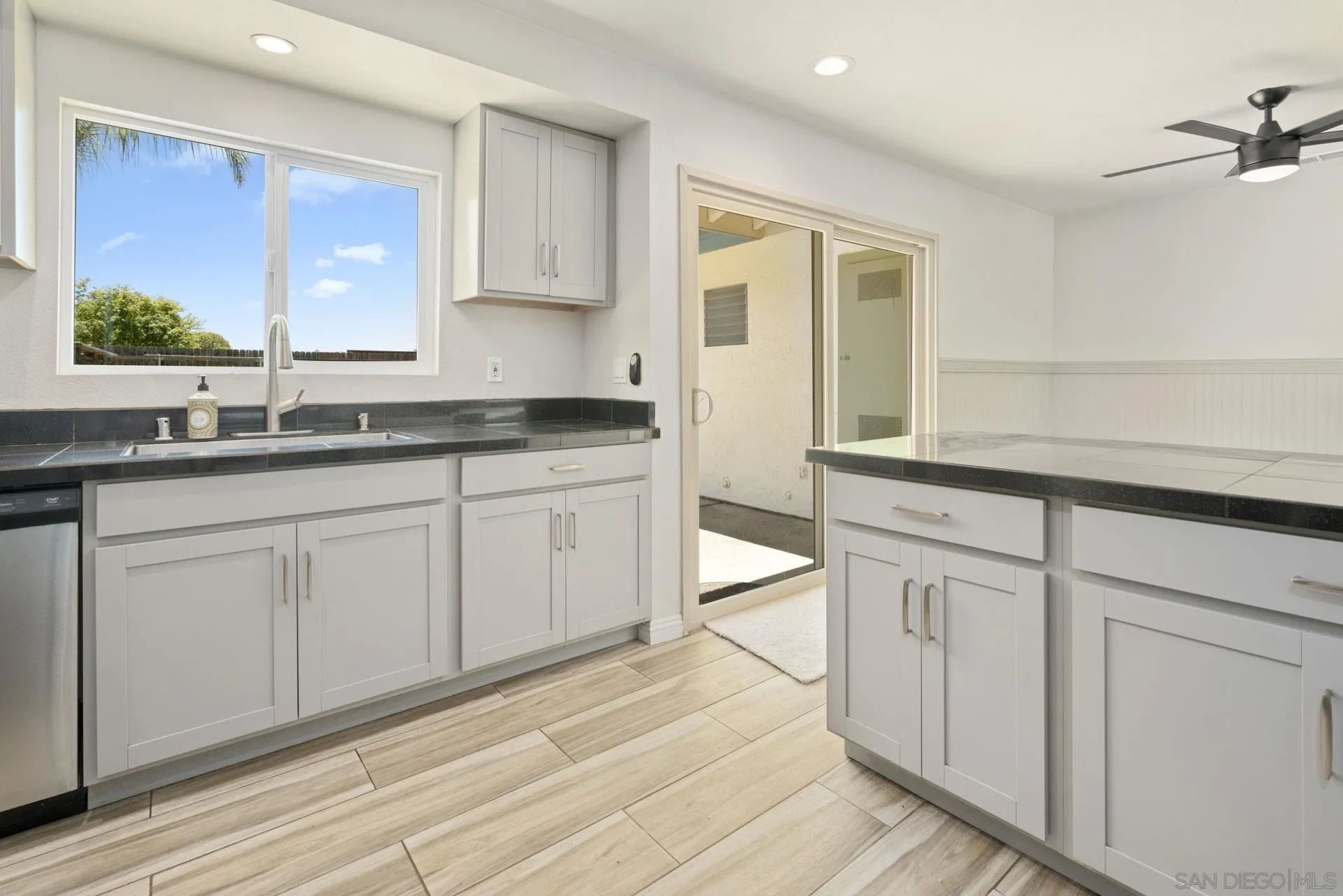 913 Buena Rosa Court Fallbrook, CA 92028 - Photo 14 of 45 a kitchen with white cabinets and sink