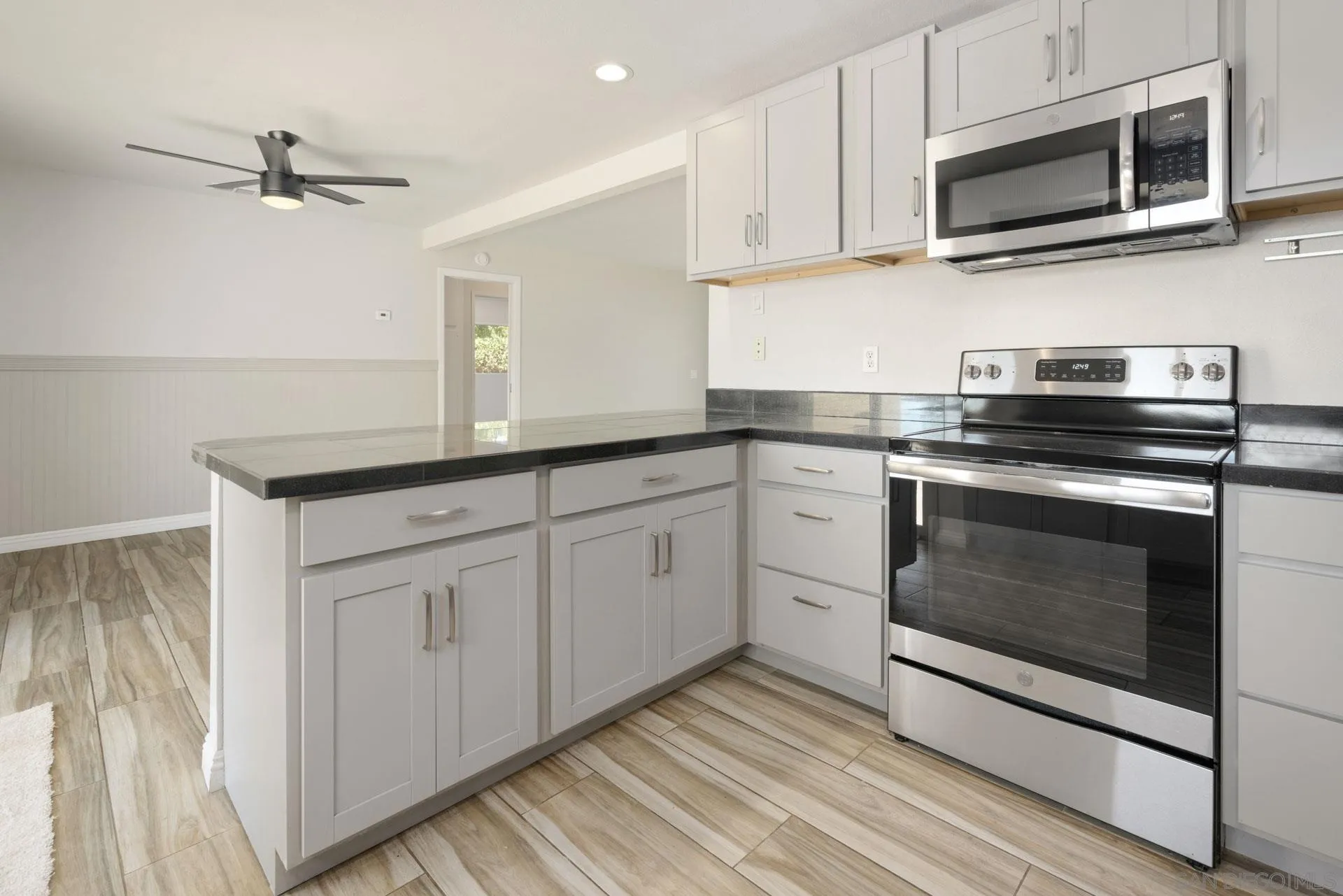 913 Buena Rosa Court Fallbrook, CA 92028 - Photo 16 of 45 a kitchen with white cabinets stainless steel appliances and sink