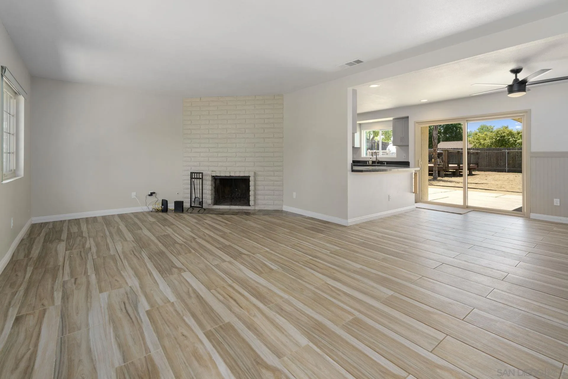 913 Buena Rosa Court Fallbrook, CA 92028 - Photo 5 of 45 a view of empty room with wooden floor and fireplace