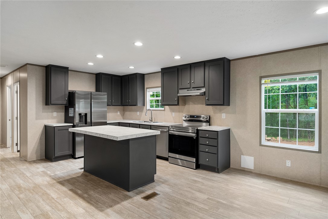 419 Austin Drive Anderson, SC 29624 - Photo 14 of 36 This bright kitchen features a functional island, ample counter space, and modern appliances.