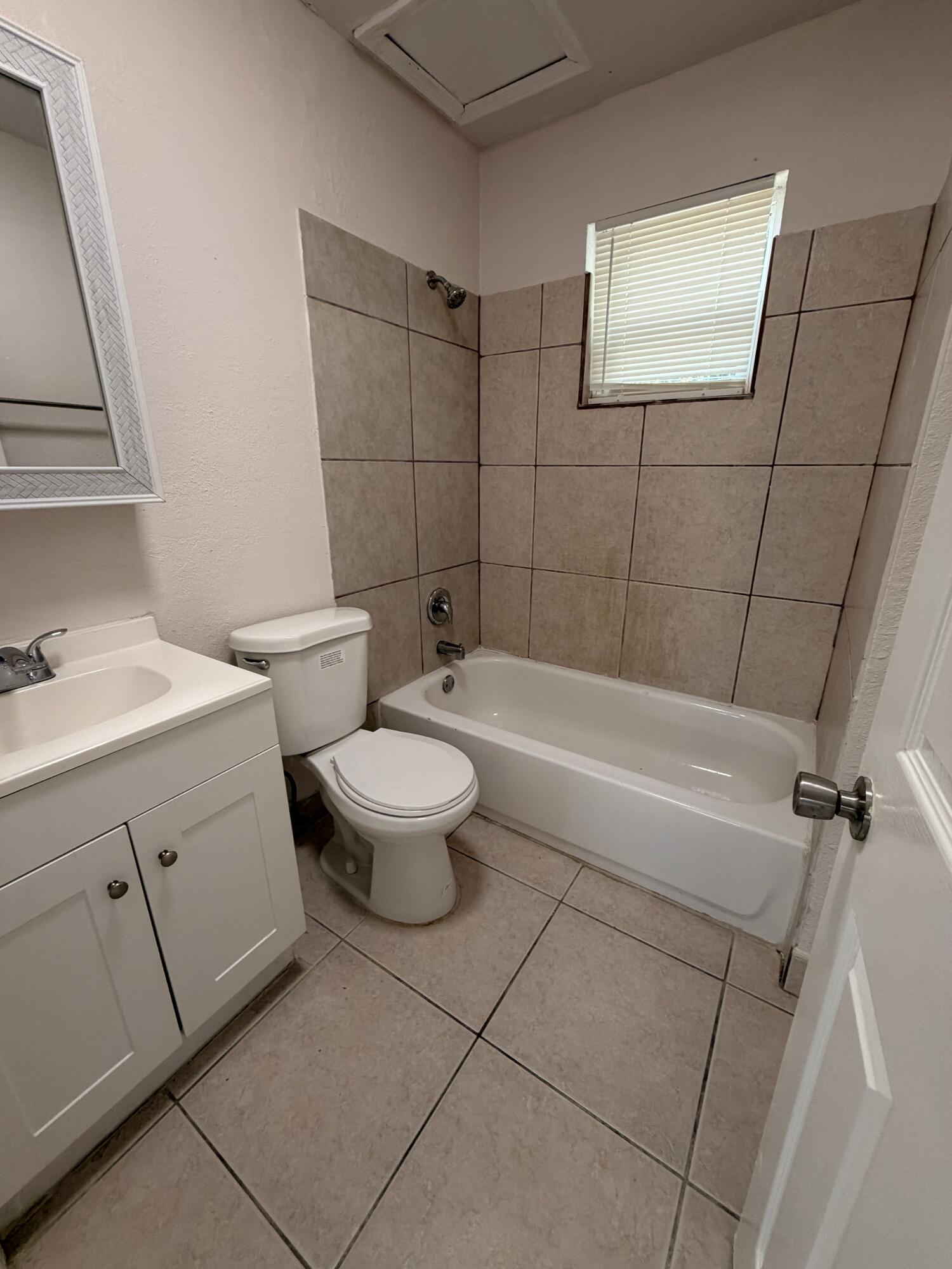 1618 West 26th Court, Unit A Riviera Beach, FL 33404 - Photo 8 of 15 a bathroom with a sink a toilet and shower