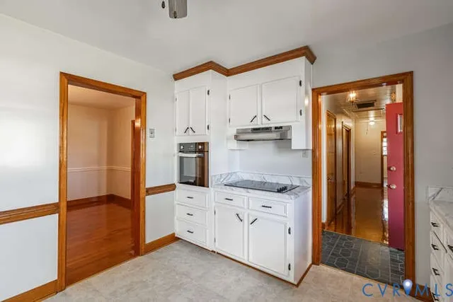 a kitchen with cabinets and a refrigerator