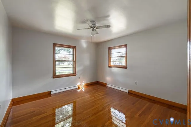 wooden floor in an empty room with a window