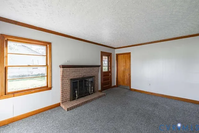 an empty room with a fireplace and window