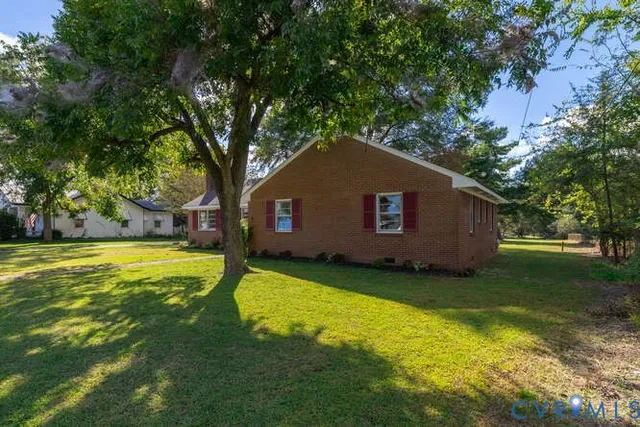 a backyard of a house with yard and trampoline