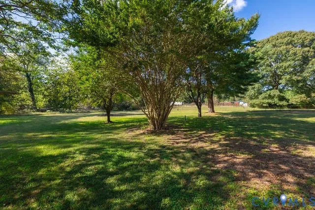 a view of grassy field with benches