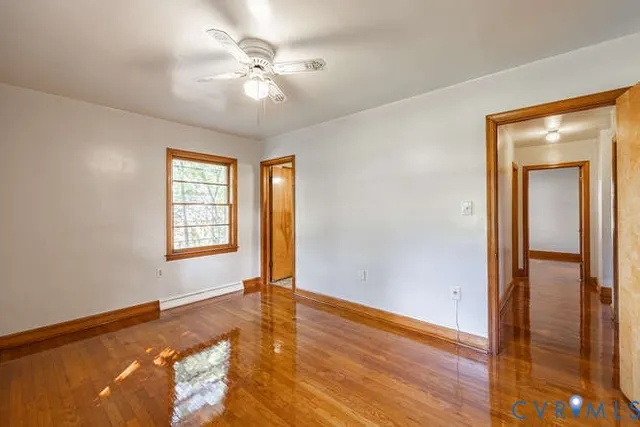 wooden floor in an empty room with a window