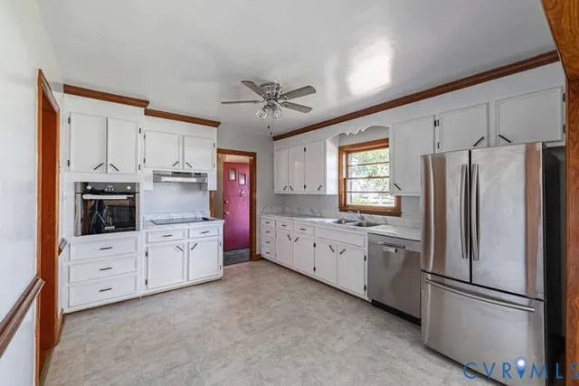 a kitchen with granite countertop a refrigerator stove and sink